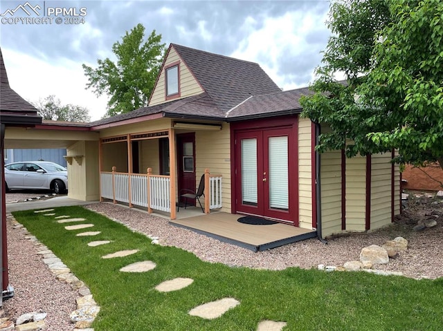 exterior space with french doors and a lawn