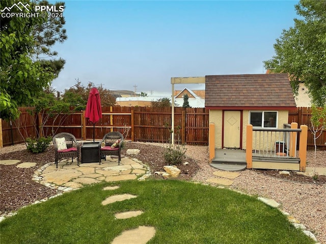 view of yard featuring a patio and an outdoor structure