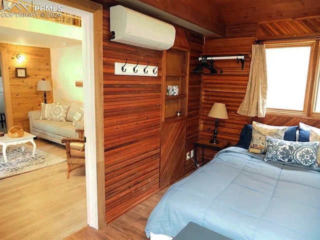 bedroom with wooden walls, an AC wall unit, beamed ceiling, and hardwood / wood-style flooring