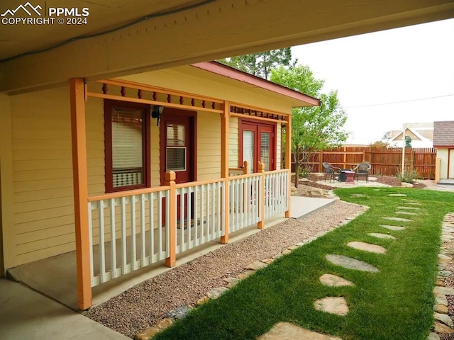 view of side of home featuring a patio and a yard