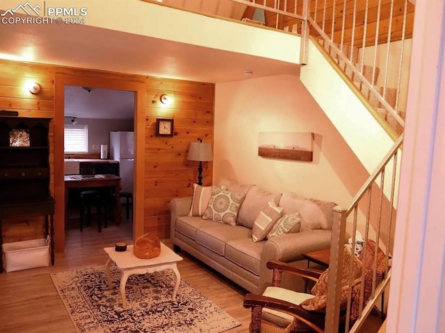 living room with wood walls and hardwood / wood-style floors