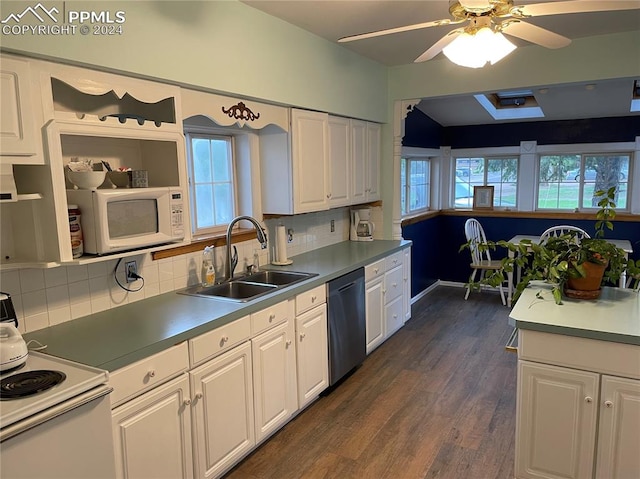 kitchen with tasteful backsplash, sink, white cabinetry, white appliances, and dark hardwood / wood-style flooring