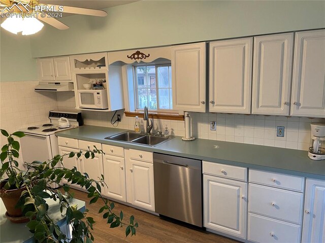 kitchen with dark hardwood / wood-style floors, tasteful backsplash, sink, white cabinets, and white appliances