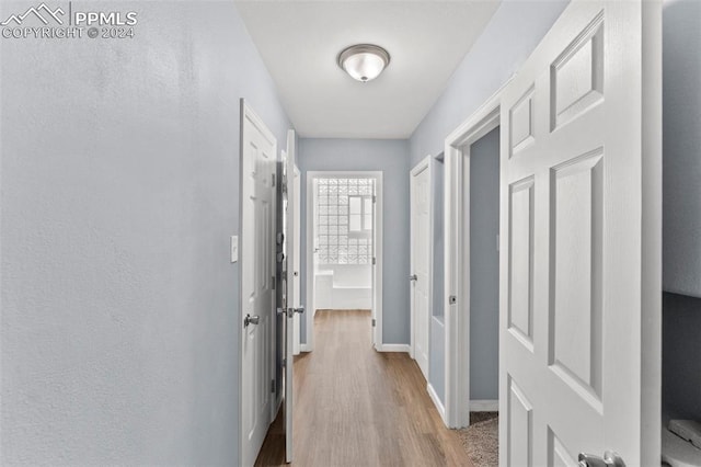 hallway with light wood-type flooring