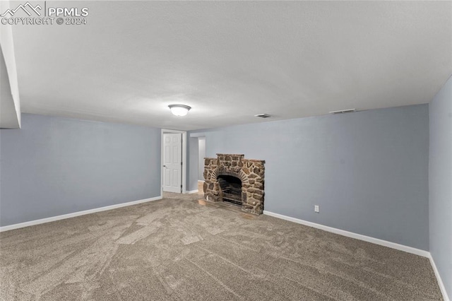 unfurnished living room featuring carpet floors and a fireplace