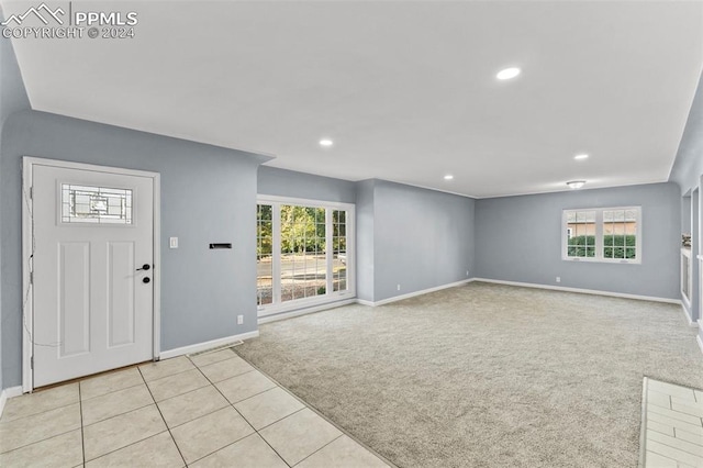 foyer entrance with light colored carpet