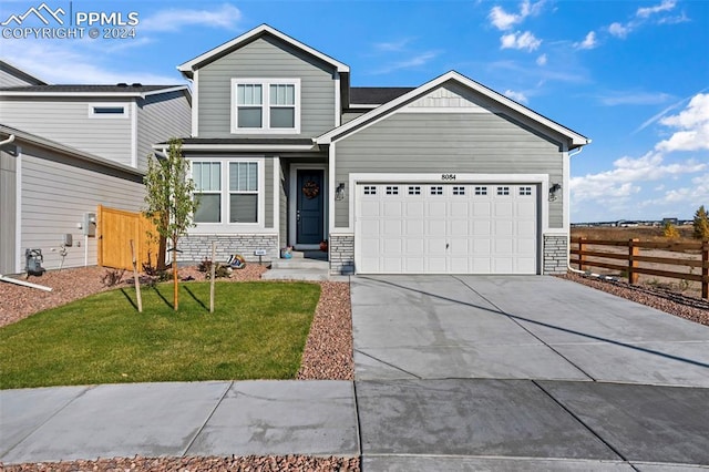 view of front facade with a front yard and a garage