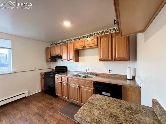 kitchen featuring sink, black appliances, a baseboard heating unit, and dark wood-type flooring