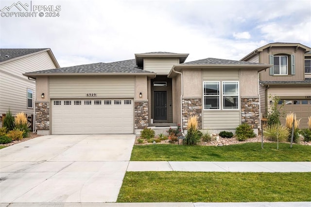 prairie-style home with a garage and a front yard