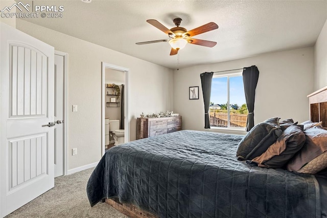 carpeted bedroom with ceiling fan, a textured ceiling, and ensuite bathroom