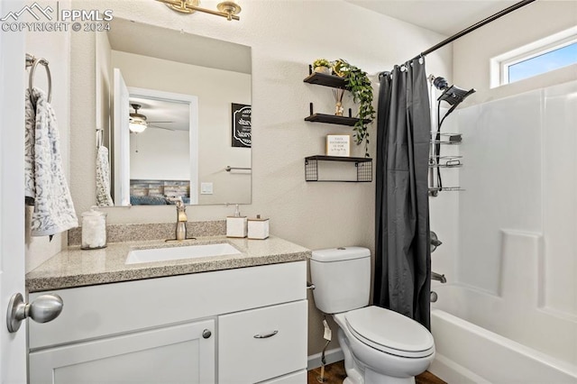 full bathroom featuring ceiling fan, shower / bath combo, vanity, and toilet