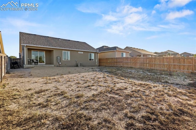 rear view of house featuring cooling unit and a patio