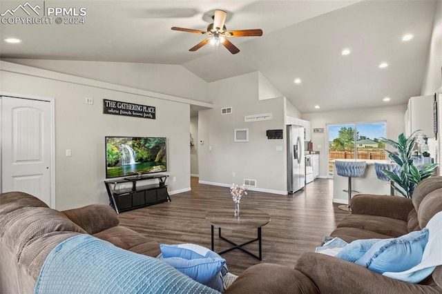 living room featuring lofted ceiling, ceiling fan, and dark wood-type flooring