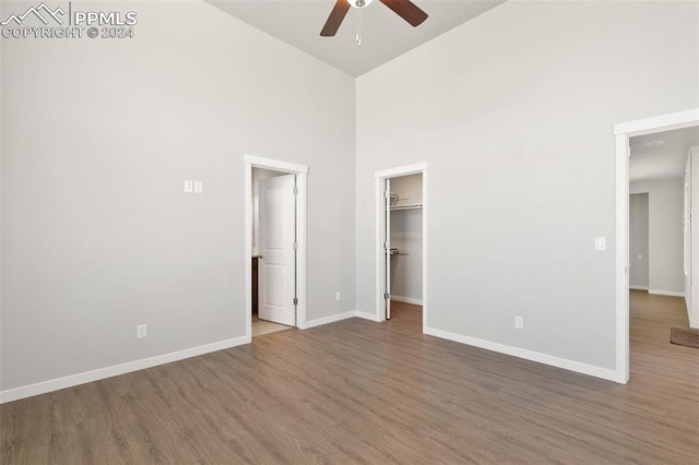 791 Little Bear Grv, Colorado Springs, CO 80907 - unfurnished bedroom featuring a high ceiling, wood finished floors, baseboards, a spacious closet, and ceiling fan