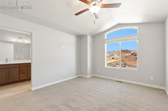 791 Little Bear Grv, Colorado Springs, CO 80907 - unfurnished bedroom with light colored carpet, vaulted ceiling, a sink, ensuite bath, and baseboards