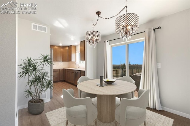 791 Little Bear Grv, Colorado Springs, CO 80907 - dining area with a chandelier, baseboards, light wood finished floors, and recessed lighting