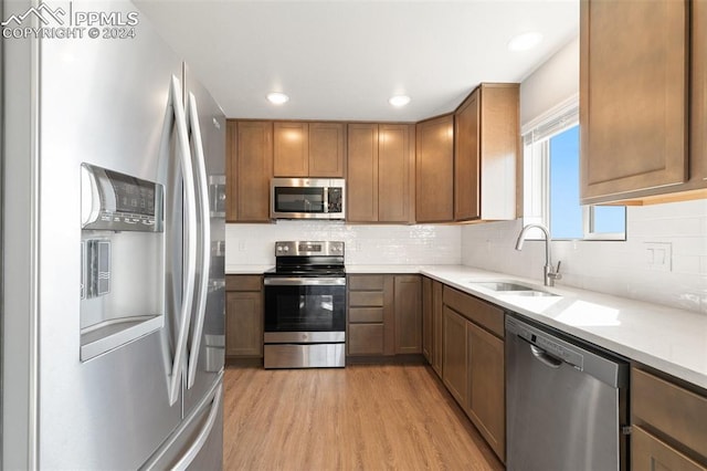 791 Little Bear Grv, Colorado Springs, CO 80907 - kitchen featuring appliances with stainless steel finishes, a sink, light wood-style flooring, light countertops, and recessed lighting