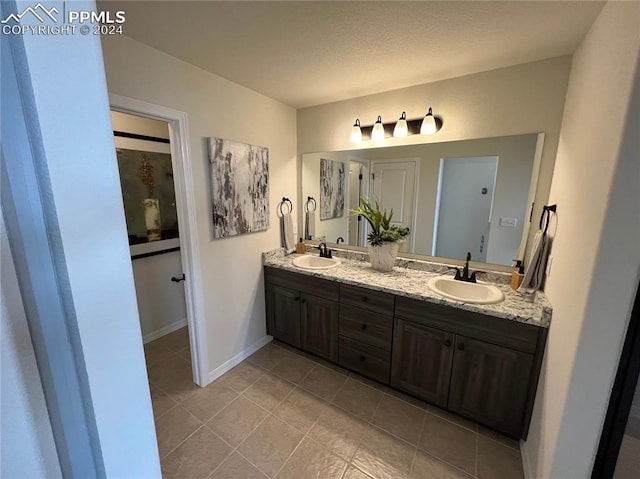 bathroom with tile patterned flooring and vanity