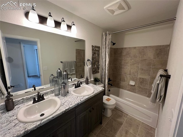 full bathroom with tile patterned flooring, shower / bath combo, vanity, and toilet