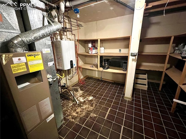 utility room with tankless water heater and heating unit