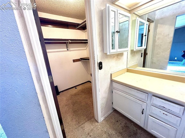 bathroom with vanity and a textured ceiling