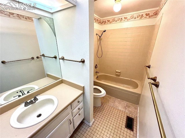 full bathroom featuring vanity, tiled shower / bath, and toilet