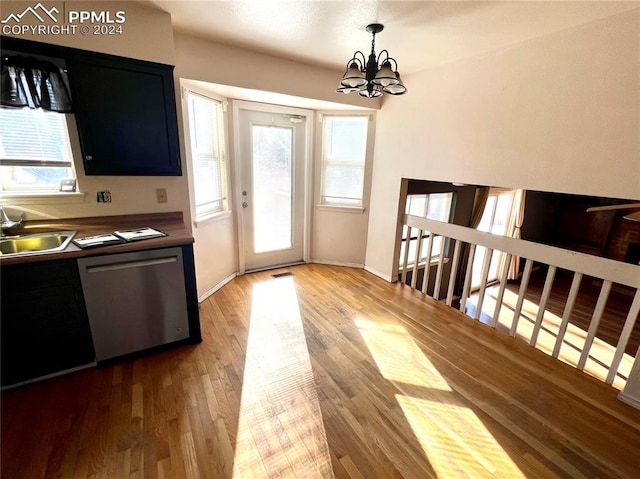 entryway featuring wood-type flooring, sink, and a notable chandelier