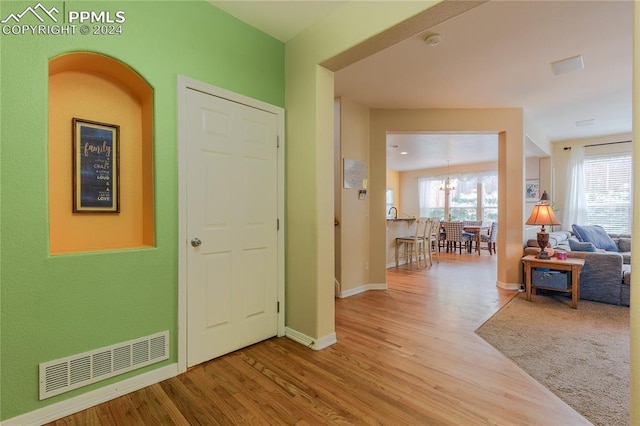 entrance foyer featuring a chandelier and light hardwood / wood-style floors