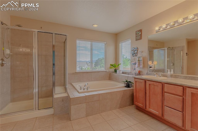 bathroom featuring vanity, shower with separate bathtub, and tile patterned flooring