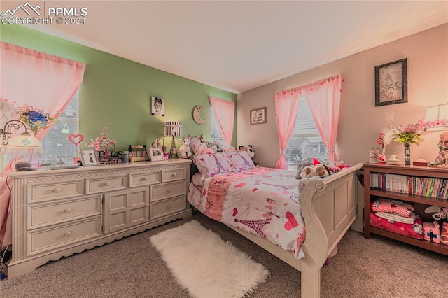 bedroom with light carpet and multiple windows