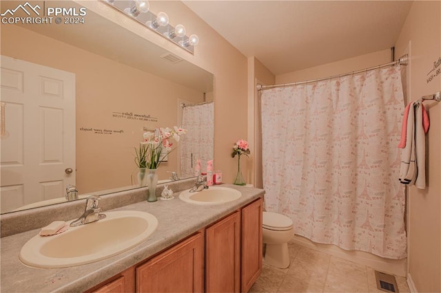 bathroom with vanity, toilet, and tile patterned floors