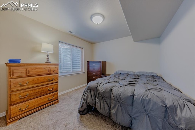 carpeted bedroom with lofted ceiling