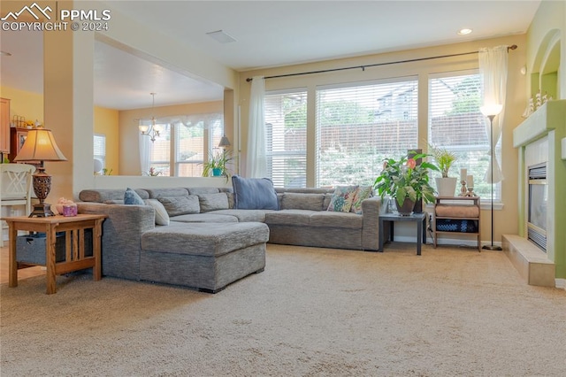 living room featuring carpet and a notable chandelier