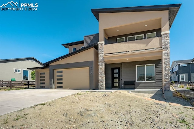 contemporary home with a balcony and a garage