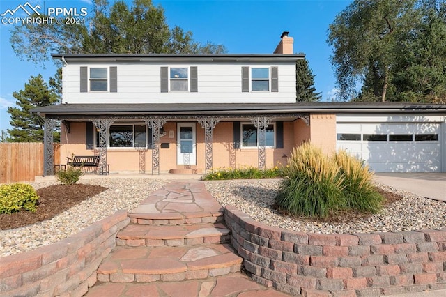 view of front of property with a garage and a porch