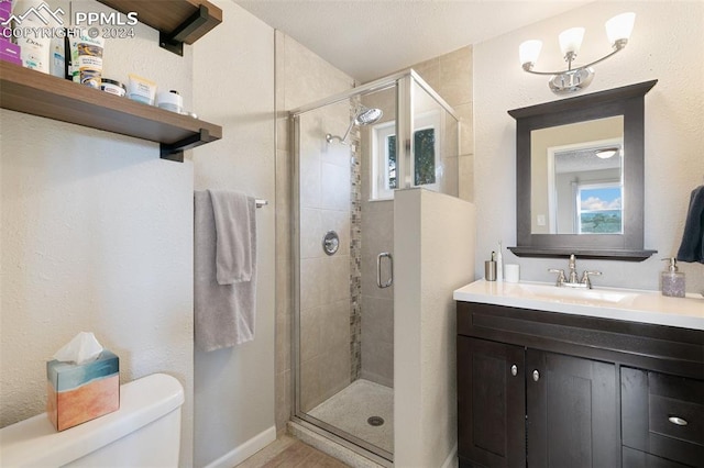 bathroom featuring walk in shower, vanity, and toilet