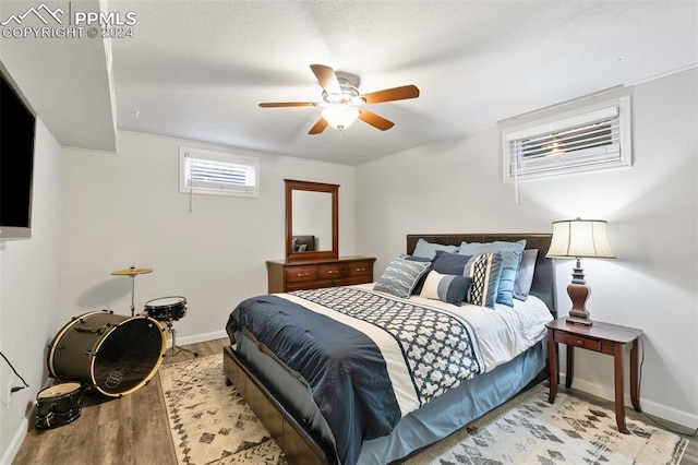 bedroom with ceiling fan and light hardwood / wood-style flooring