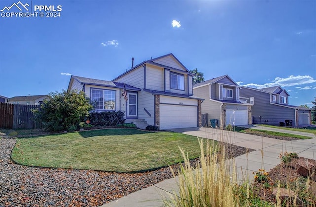 view of property with a garage and a front lawn