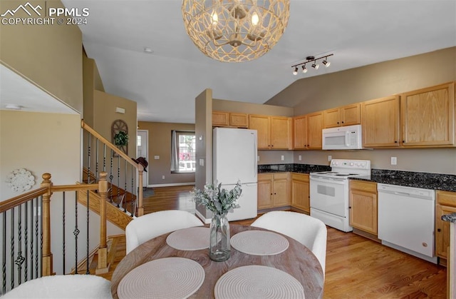 kitchen with light hardwood / wood-style floors, white appliances, light brown cabinets, lofted ceiling, and hanging light fixtures