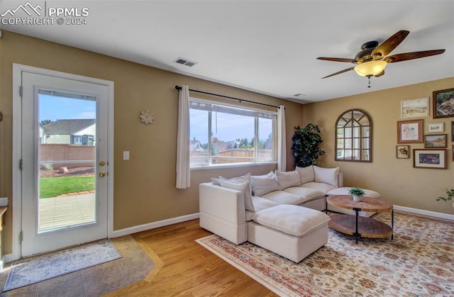 living room featuring ceiling fan and light hardwood / wood-style flooring