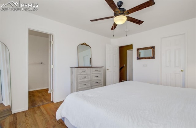 bedroom with ceiling fan and light wood-type flooring