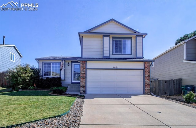 view of front property featuring a front lawn and a garage