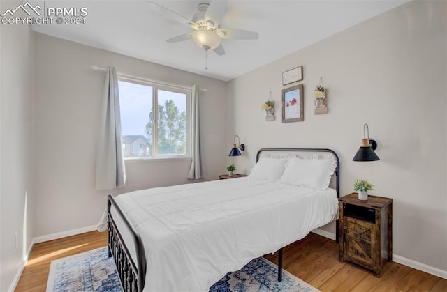 bedroom with hardwood / wood-style floors and ceiling fan