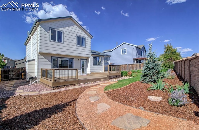 rear view of house featuring a deck