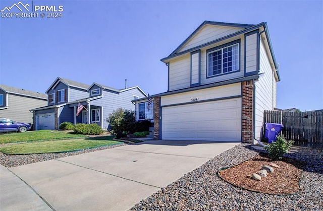 front of property featuring a garage and a front lawn