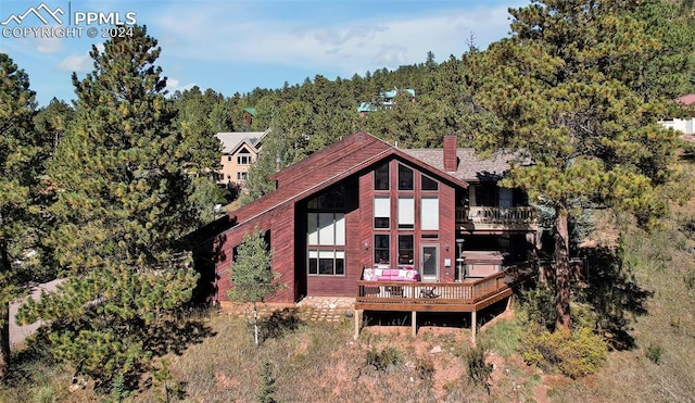 back of property with a wooden deck