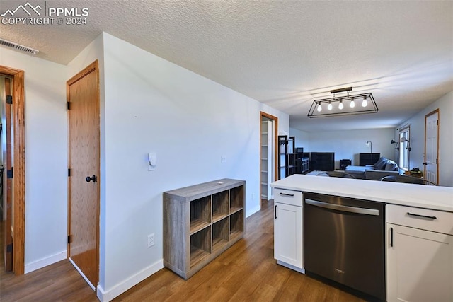 kitchen featuring white cabinets, wood-type flooring, and dishwasher