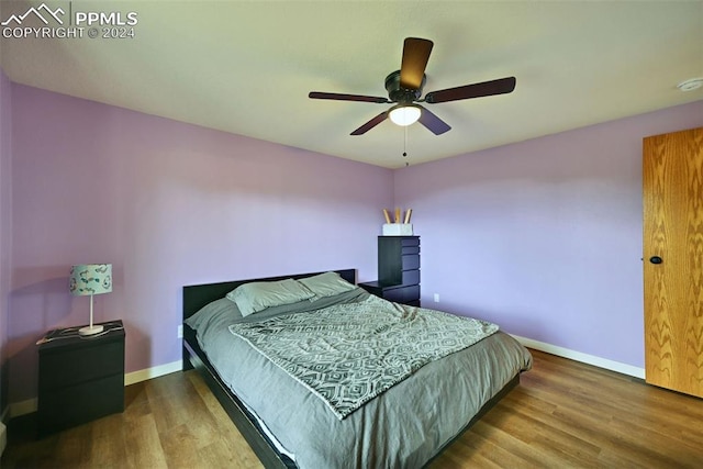 bedroom featuring wood-type flooring and ceiling fan