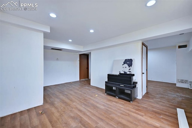 basement featuring hardwood / wood-style flooring