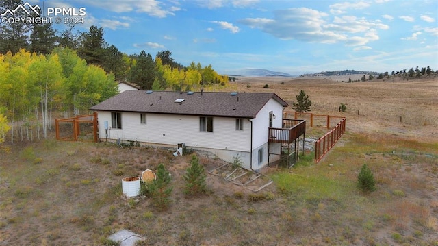 rear view of property featuring a mountain view